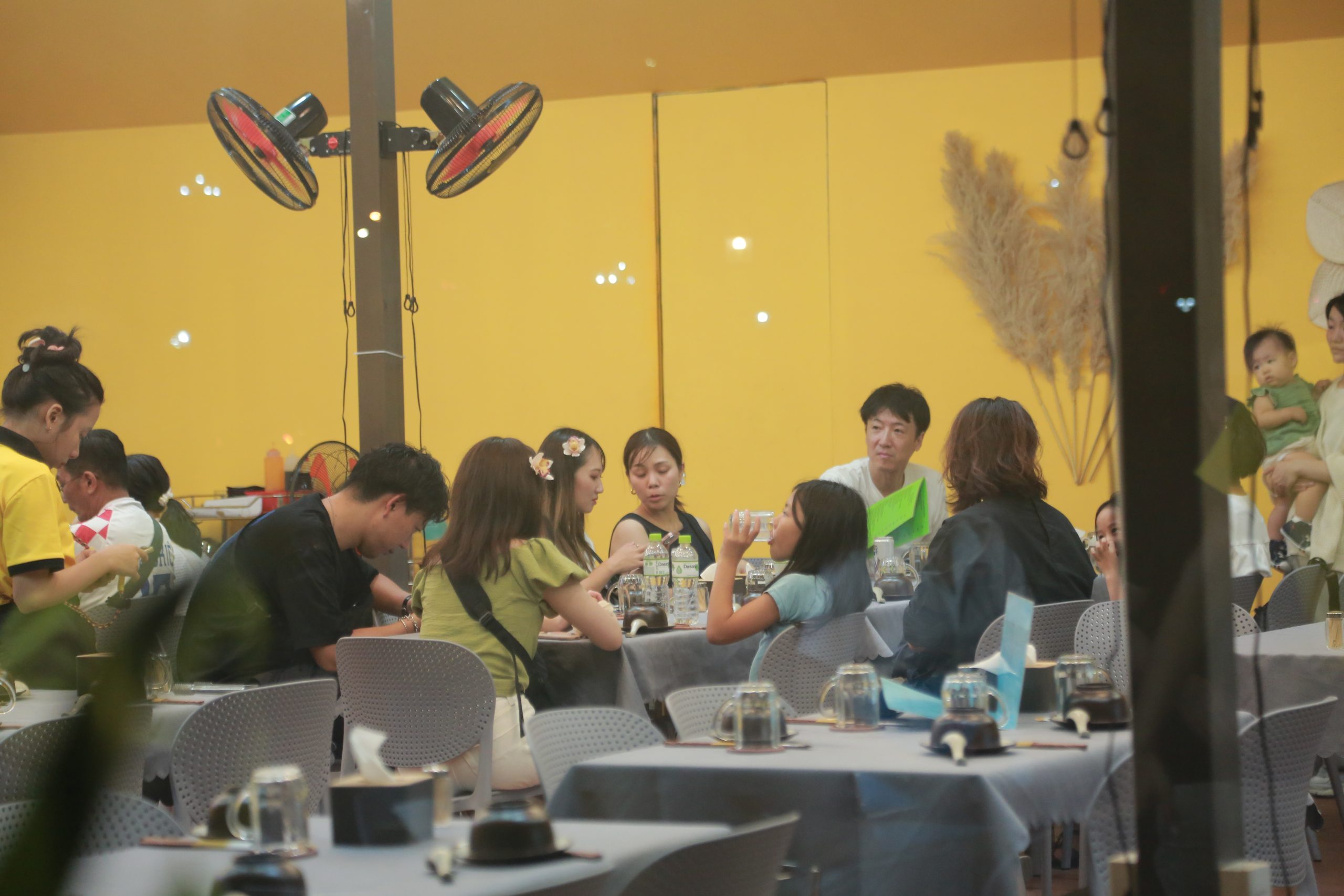 Tourists enjoying their meal at a Seafood restaurant near the beach.
