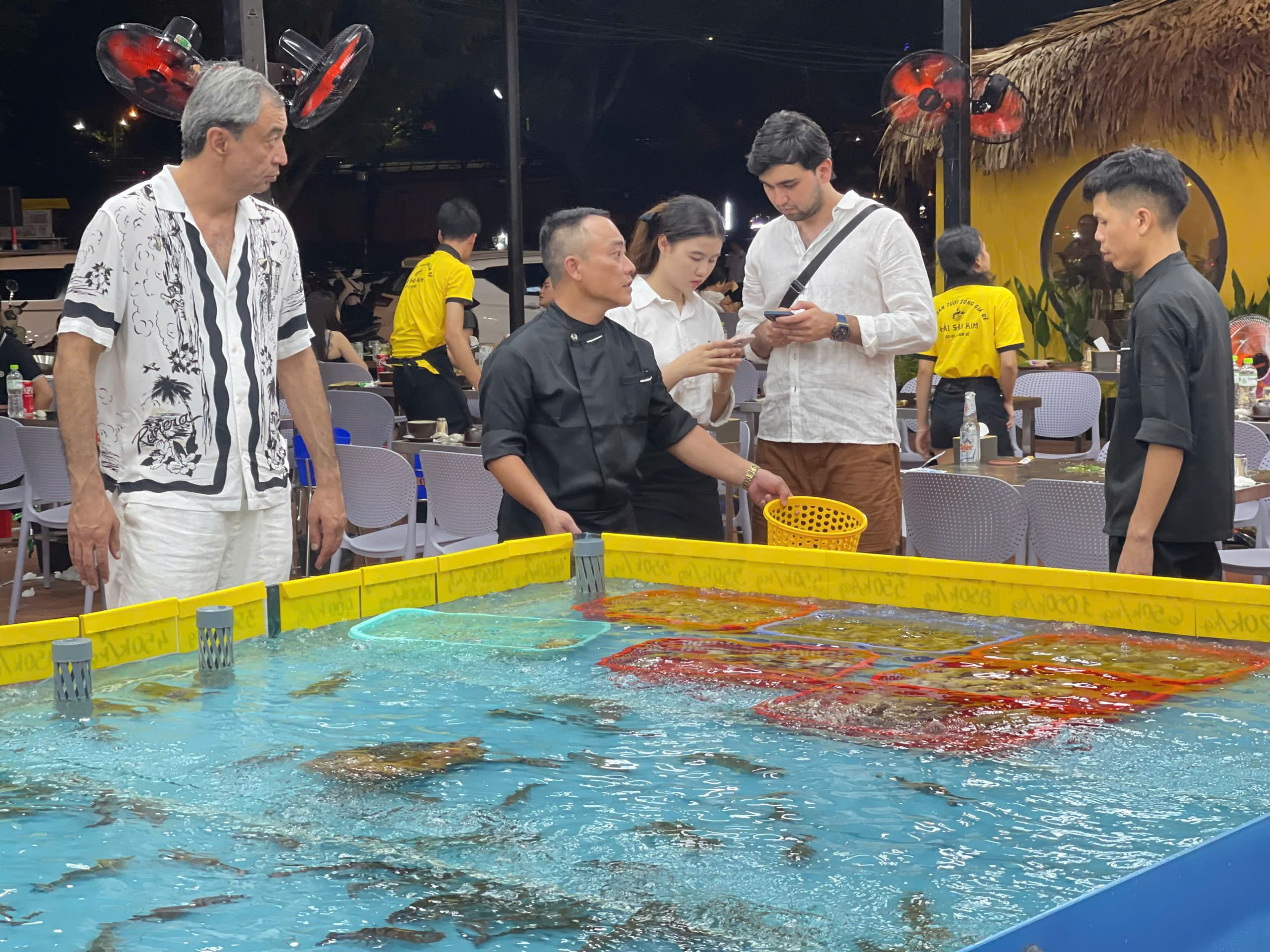 Customers choose seafood from the tanks at Kim Seafood restaurant.