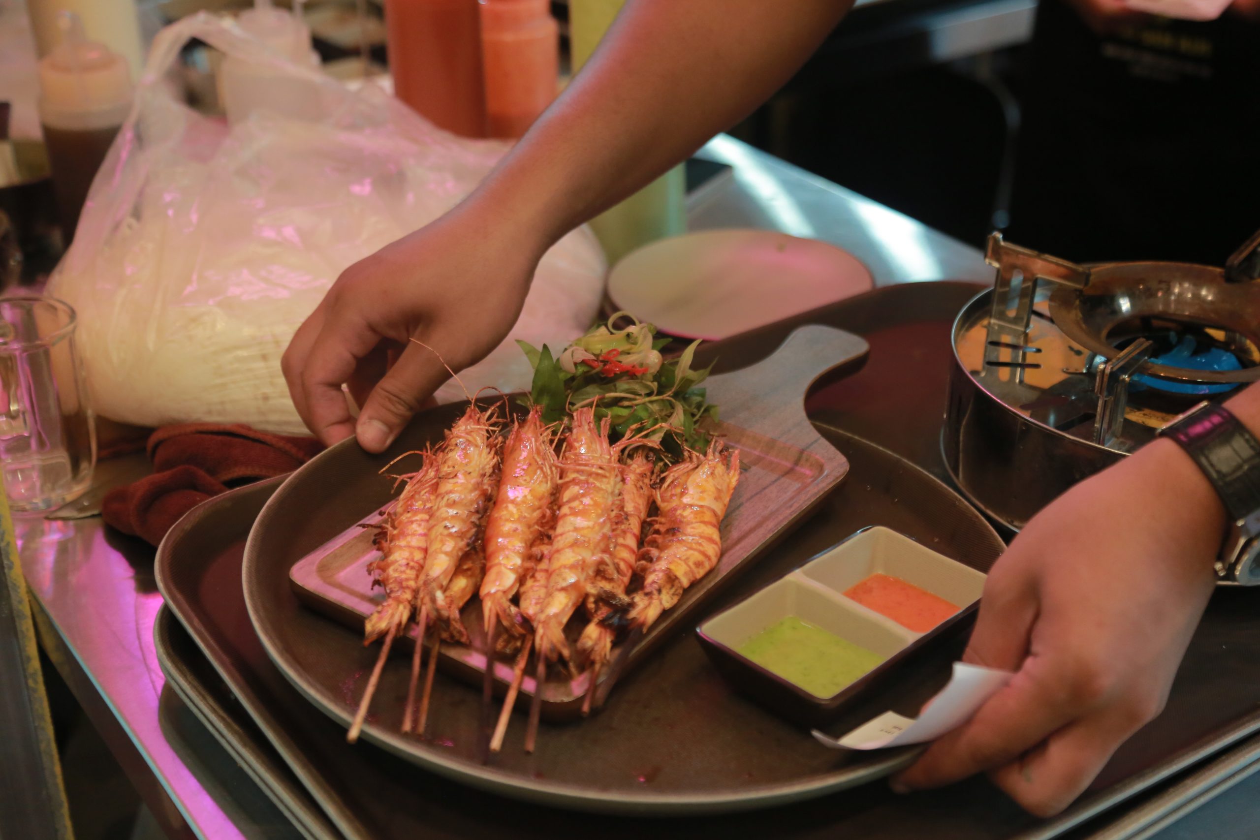 Staff serve delicious seafood dishes