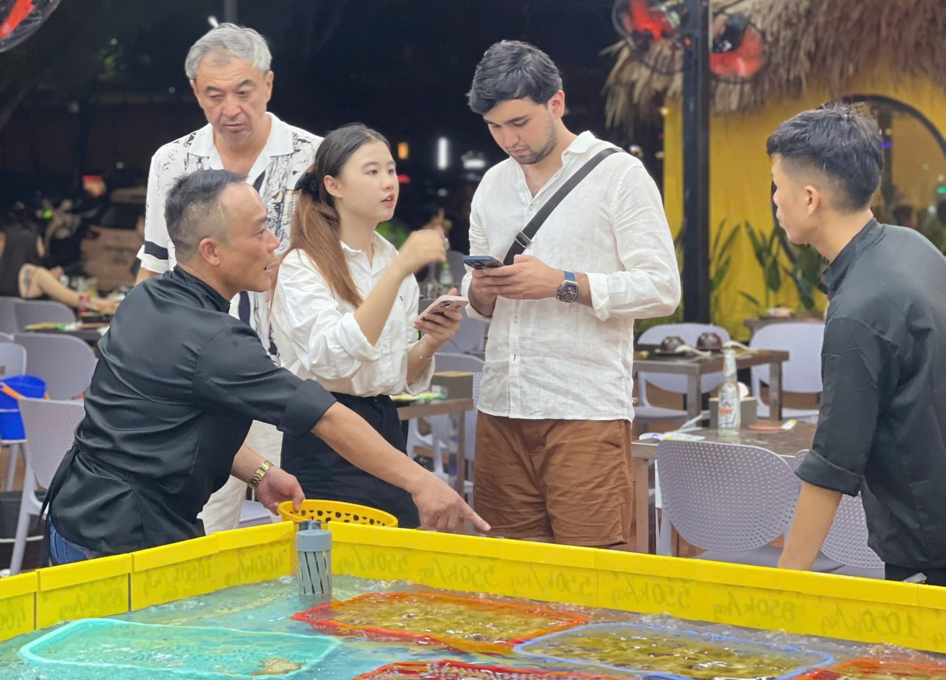 Staff advising customers at a familiar seafood restaurant popular with locals